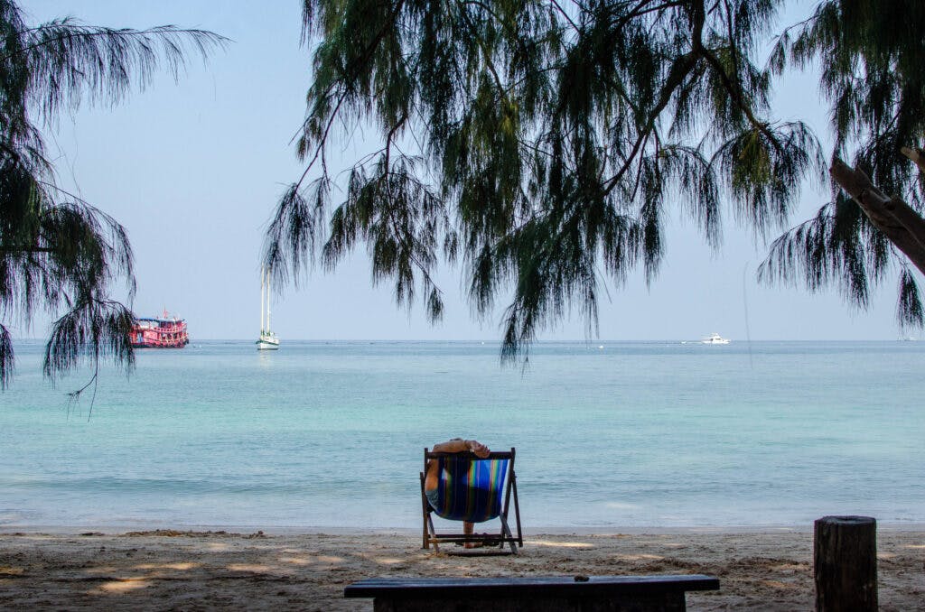 A lounge chair on the beach on koh tao, overlooking the peaceful bay. 