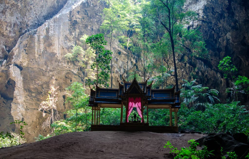A huge cave in Thailand with a little temple inside.