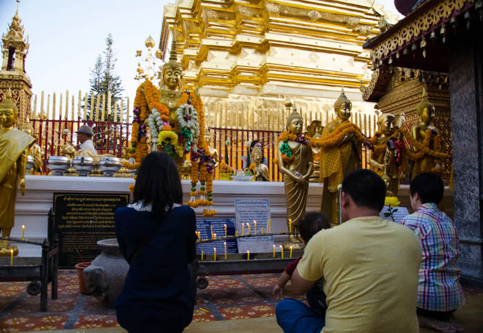 Family praying at the Doi Suthep temple, Chiang Mai