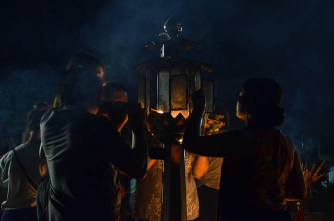 The candles are lit from a flame, which burns constantly in this little glass lantern at Wat Jed Yod