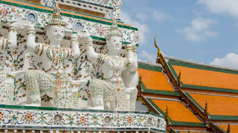 Beautiful, white buddha statues at Wat Arun in Bangkok