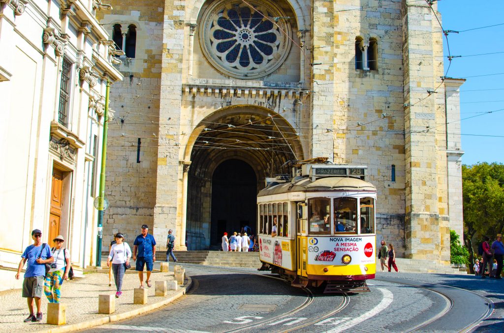 tram 28 passing a church in lisbon