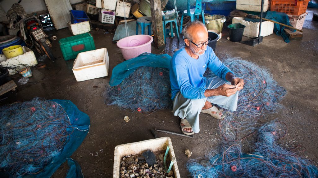 fisherman in rayong cleaning nets