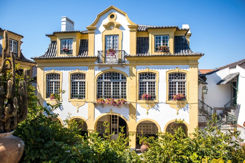 yellow house in José Maria de Fonseca  winery standing in the sun in the garden 