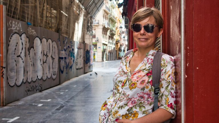 joanna horanin smiles at the camera on an empty street in valencia