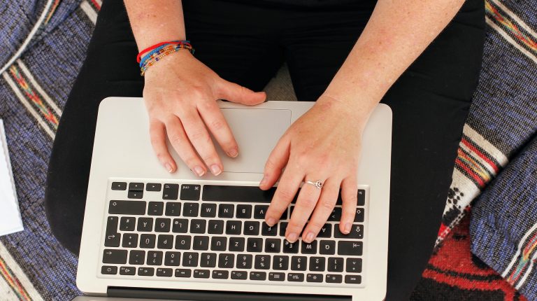 digital nomad writing on a computer