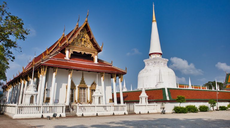 a thai temple in nakhon si thammarat with a white chedi