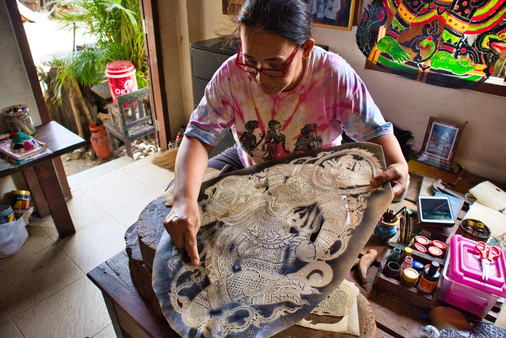 a woman shows how to make shadow puppets in nakhon si thammarat