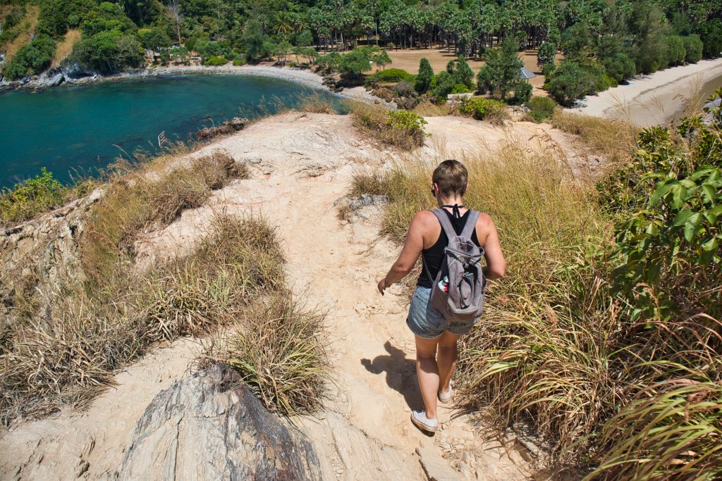 a woman walking downhill in mu koh lanta, thailand.