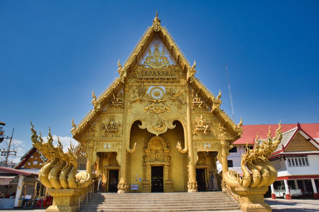 A golden temple against the blue sky.