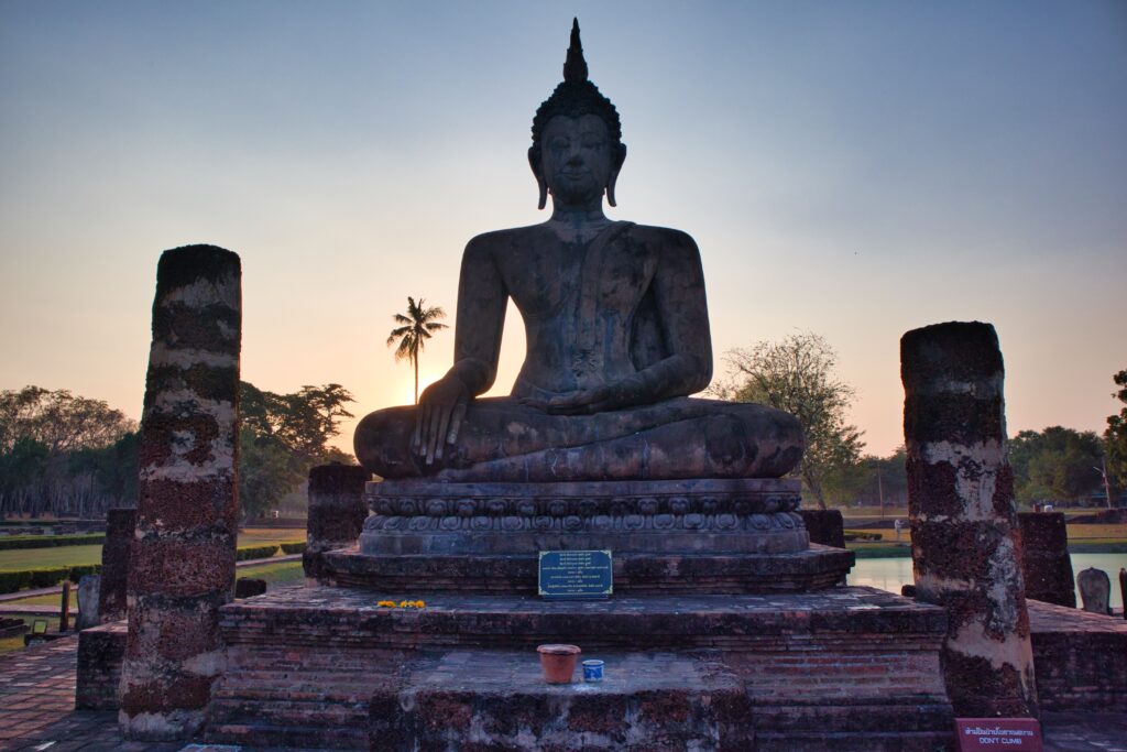A statue of a buddha at historic park in sukothai.