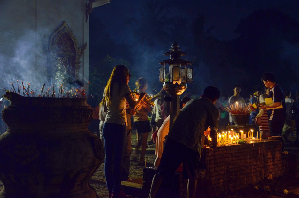 People lighting candles during Makha Bucha in Chiang Mai